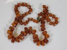 An antique irregular shaped amber necklace