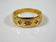 An 18ct gold ring set with three diamonds size O 3