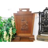 An early 20thC. teak firescreen with plaque to rea