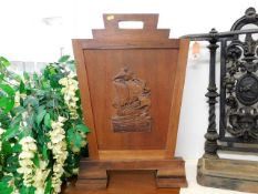An early 20thC. teak firescreen with plaque to rea