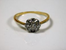 An 18ct gold daisy ring set with 0.5ct diamonds si