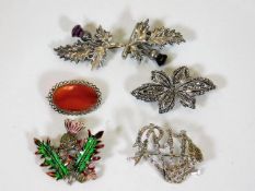 Four Scottish related brooches & one other