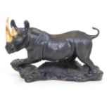 A Franklin Mint bronze rhino with gold plated tusk