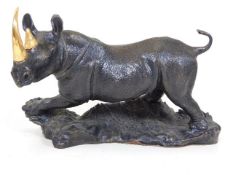 A Franklin Mint bronze rhino with gold plated tusk