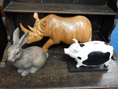 A large carved wooden rhino, a similar rabbit & a