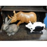 A large carved wooden rhino, a similar rabbit & a