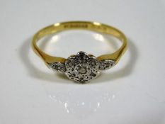 An 18ct gold ring set with small diamonds in white