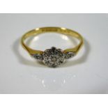 An 18ct gold ring set with small diamonds in white