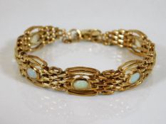 A 9ct gold bracelet set with seven opals 23.7g