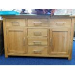 A contemporary oak sideboard 55in long