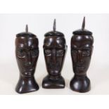 Three c.1900 lignum vitae carved head pots with co