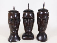 Three c.1900 lignum vitae carved head pots with co