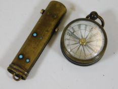 A miniature brass cased compass twinned with a cha