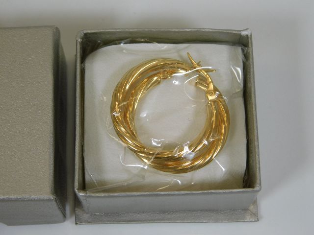 A boxed & sealed as new pair of 9ct gold earrings