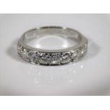 An 18ct white gold ring set with nine diamonds of