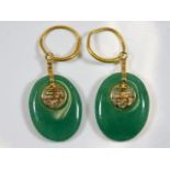 A pair of Chinese jade earrings mounted with fine