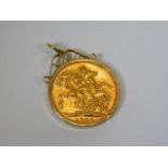 A 9ct gold mounted 1906 22ct full gold sovereign 9