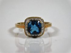 A 9ct gold ring with centre blue stone set with sm