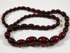 An early 20thC. set of cherry amber style beads 59