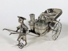 A Chinese silver cruet set depicting man with rick