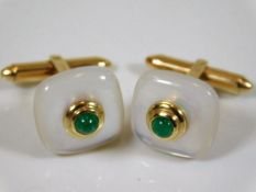 A fine pair of mother of pearl & emerald cufflinks