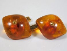 A pair of Russian marked yellow metal amber cuffli