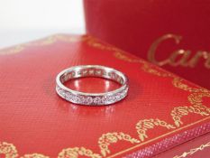 An 18ct white gold Cartier eternity ring set with