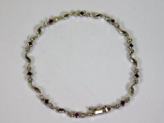 A 14ct white gold diamond & ruby bracelet 7.6in lo