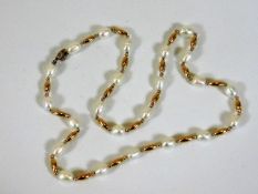 A freshwater pearl necklace with yellow metal spac