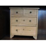 A miniature chest of pine drawers