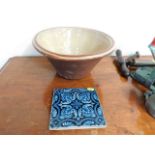 A Minton tile twined with a stoneware mixing bowl