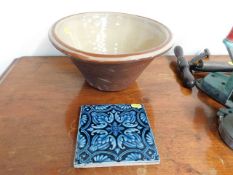 A Minton tile twined with a stoneware mixing bowl