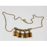 An 18ct gold chain with letter plaques spelling LO