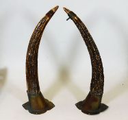 A pair of horns mounted on silver plate 14in high