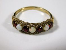 A 9ct gold ring set with opal & garnet 1.9g size O