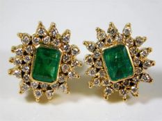 A pair of 18ct gold earrings set with emerald & di