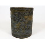 A Chinese brass brush pot depicting the eight Immortals crossing the sea 5in high x 4.25in wide. Pro