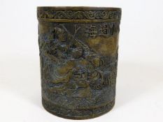 A Chinese brass brush pot depicting the eight Immortals crossing the sea 5in high x 4.25in wide. Pro