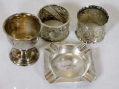 A silver egg cup, a small silver ashtray & two odd