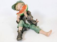 A Capodimonte figure of boy eating watermelon sign