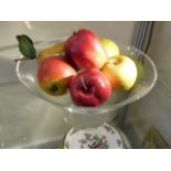 A modern crystal bowl with fake fruit