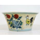 A Chinese porcelain tea bowl depicting birds & flo