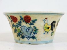 A Chinese porcelain tea bowl depicting birds & flo