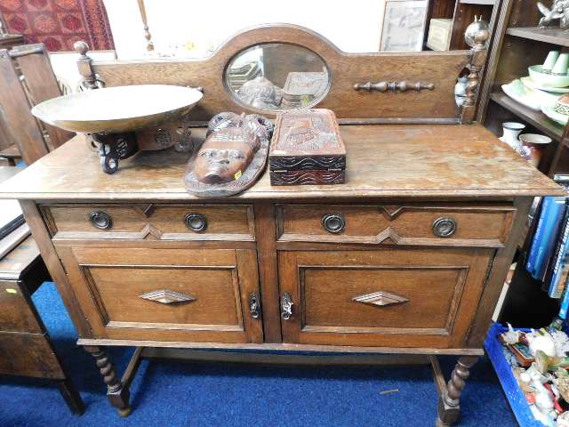 An early 20thC. oak sideboard with cupboard under