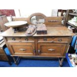 An early 20thC. oak sideboard with cupboard under