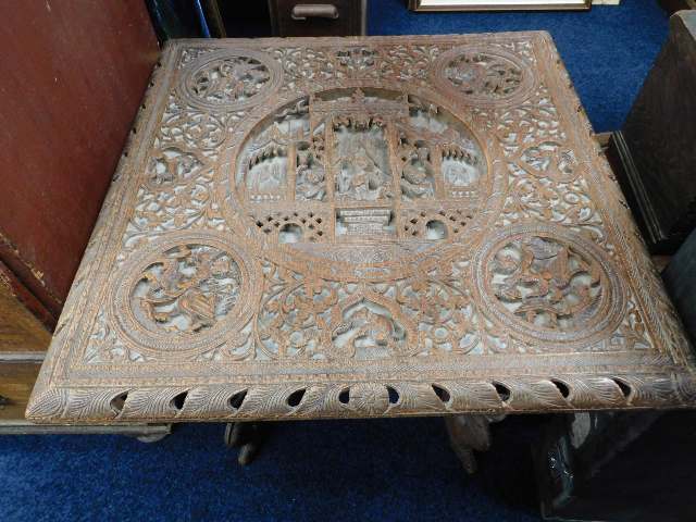 A heavily Eastern carved table & stand