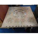 A heavily Eastern carved table & stand