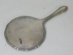 A silver mounted hand held dressing table mirror