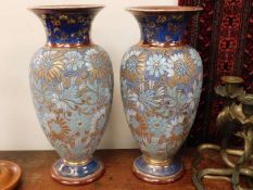 A pair of large Doulton stoneware vases, one repai