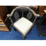 A c.1900 carved oak corner chair